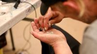 A man waits to have a sample of drugs tested by Vancouver Coastal Health workers at the Overdose Prevention Society in Vancouver (Briar Stewart/CBC)